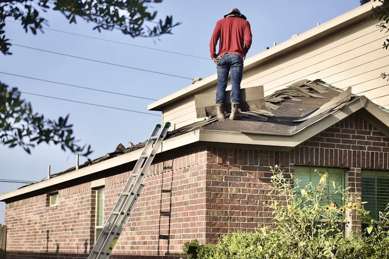 Professional roofer working on a residential roof in Reynolds Bridge